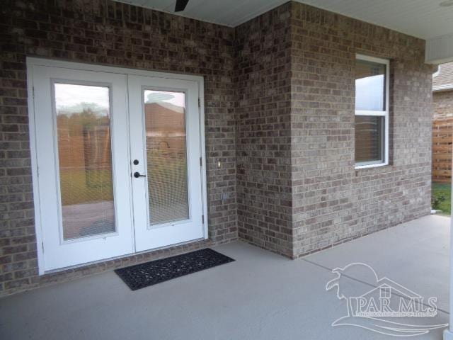 view of exterior entry featuring a patio and french doors