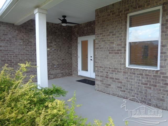 doorway to property featuring a patio area and ceiling fan