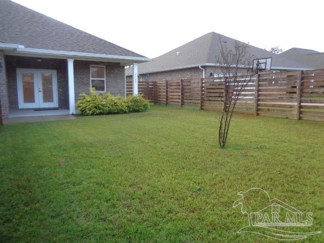 view of yard featuring french doors