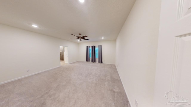 unfurnished room featuring light colored carpet and ceiling fan