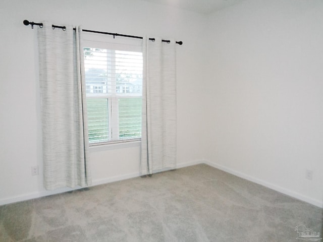 unfurnished room with light carpet