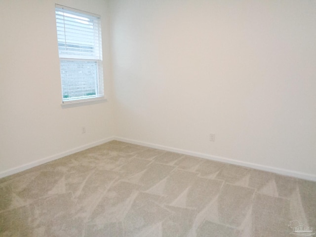 unfurnished room featuring light carpet