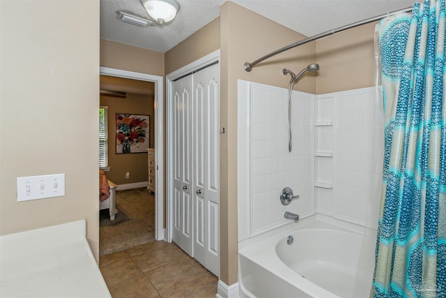 bathroom with shower / bathtub combination with curtain, a textured ceiling, and tile patterned floors