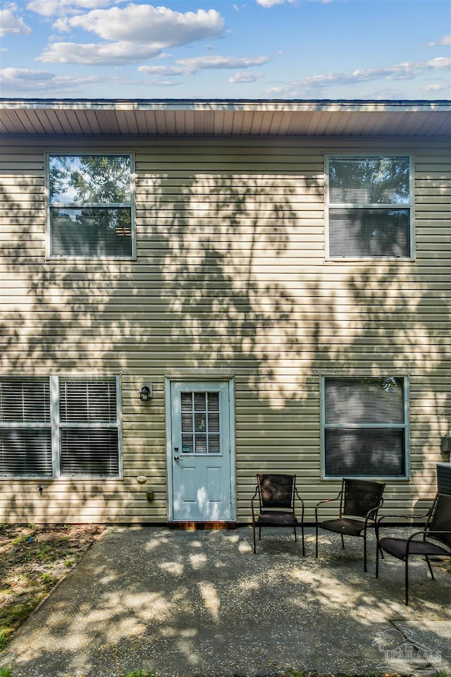 back of property with a patio