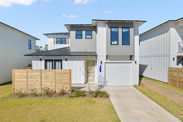 13844 Red Drum Ct, Perdido Key, FL 32507 - view of front of property with board and batten siding, concrete driveway, an attached garage, a metal roof, and a standing seam roof