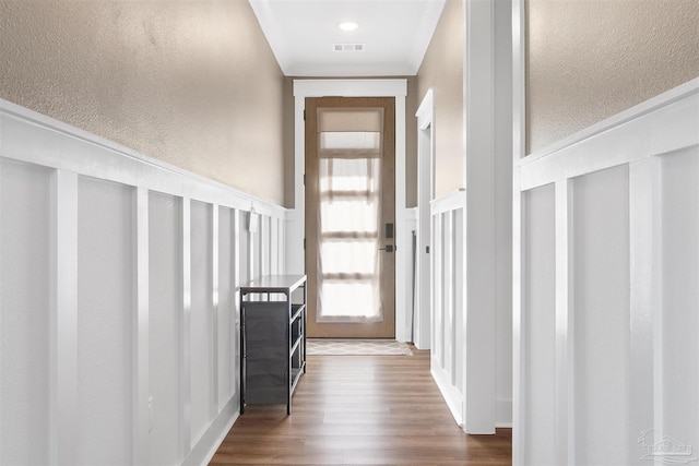 13844 Red Drum Ct, Perdido Key, FL 32507 - doorway to outside with a decorative wall, a textured wall, dark wood-type flooring, and wainscoting