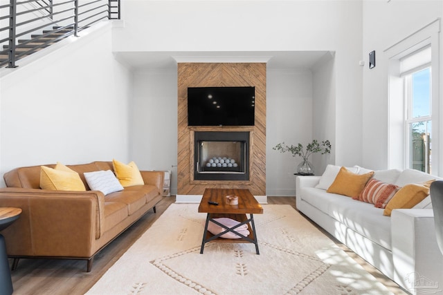 13844 Red Drum Ct, Perdido Key, FL 32507 - living area featuring wood finished floors, a large fireplace, and a high ceiling