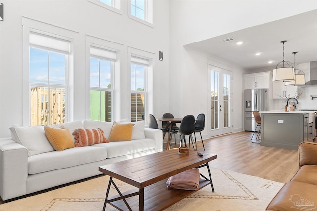 13844 Red Drum Ct, Perdido Key, FL 32507 - living area with light wood-style floors, recessed lighting, and a towering ceiling