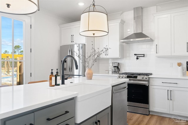 13844 Red Drum Ct, Perdido Key, FL 32507 - kitchen with wall chimney range hood, appliances with stainless steel finishes, gray cabinetry, light countertops, and recessed lighting