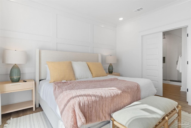 13844 Red Drum Ct, Perdido Key, FL 32507 - bedroom featuring wood finished floors, ornamental molding, recessed lighting, and a decorative wall