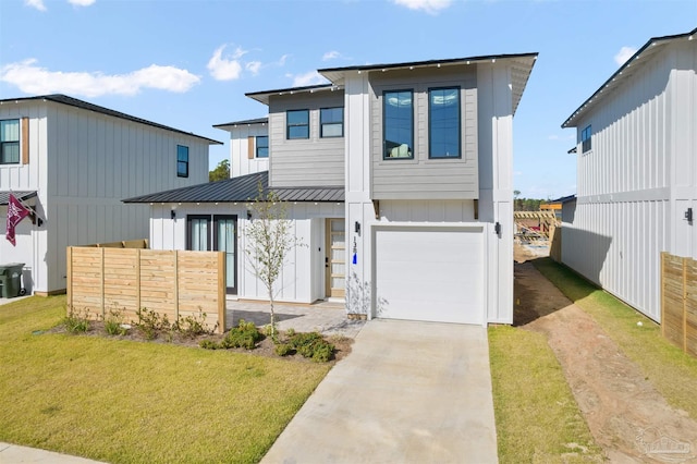13844 Red Drum Ct, Perdido Key, FL 32507 - view of front of house with an attached garage, driveway, a metal roof, a standing seam roof, and board and batten siding