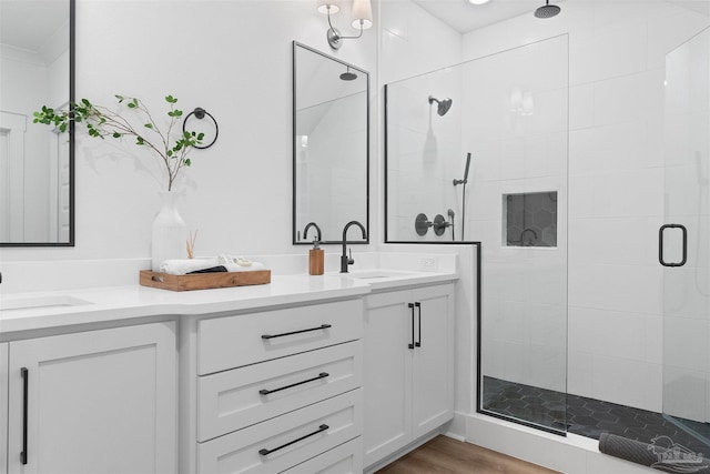 13844 Red Drum Ct, Perdido Key, FL 32507 - bathroom with double vanity, a stall shower, and wood finished floors