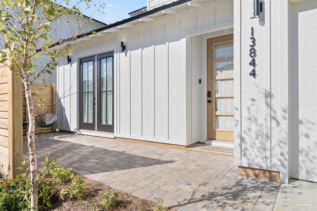 13844 Red Drum Ct, Perdido Key, FL 32507 - entrance to property featuring a patio area, french doors, and board and batten siding