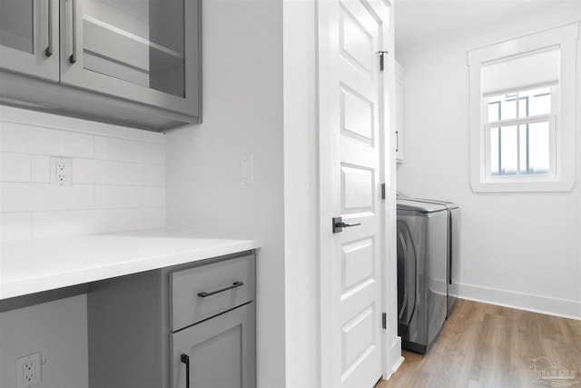 13844 Red Drum Ct, Perdido Key, FL 32507 - laundry room featuring independent washer and dryer, cabinet space, and light wood finished floors