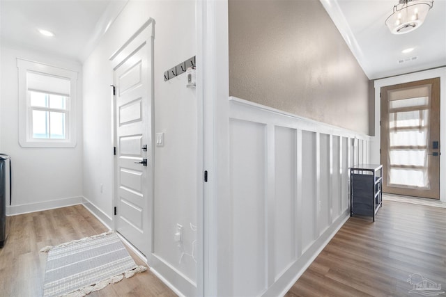 13844 Red Drum Ct, Perdido Key, FL 32507 - entrance foyer with wood finished floors, a wainscoted wall, and a decorative wall
