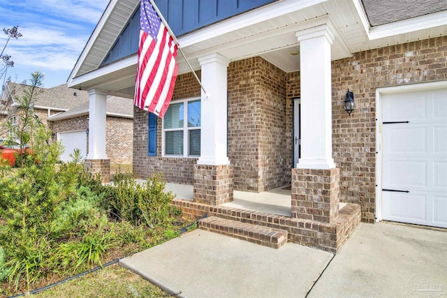 entrance to property with covered porch and a garage