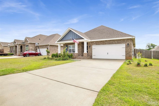 craftsman-style home with brick siding, a front lawn, driveway, and an attached garage