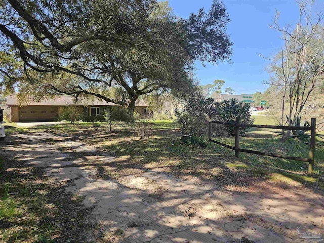 12741 S Santa Piedro, Lillian, AL 36549 - view of yard with an attached garage, fence, and driveway