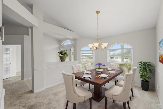 dining area featuring an inviting chandelier, carpet, baseboards, and lofted ceiling