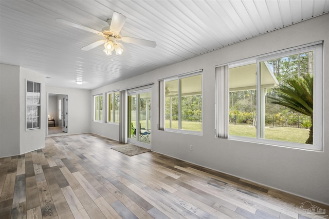 unfurnished sunroom with a ceiling fan