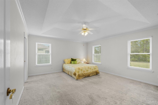 bedroom with multiple windows, a textured ceiling, crown molding, and carpet