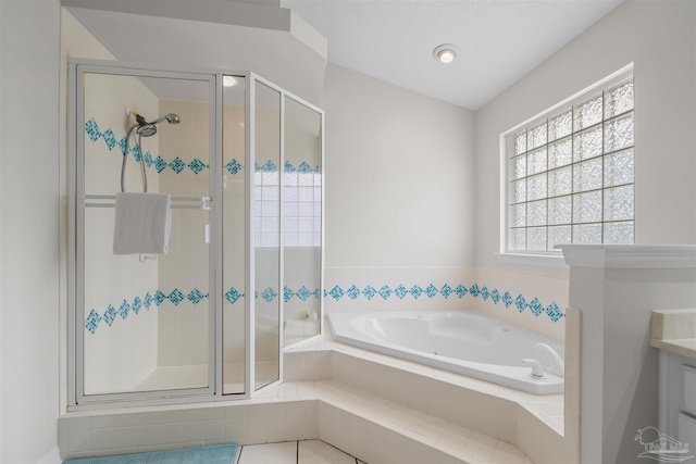 bathroom featuring a stall shower, vanity, and a garden tub