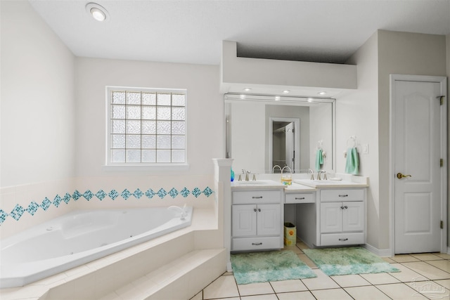 bathroom featuring tile patterned flooring, vanity, and a whirlpool tub