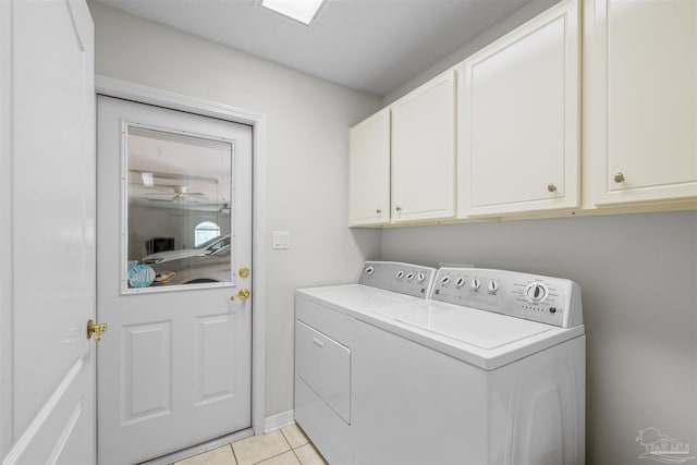 washroom featuring light tile patterned floors, cabinet space, and independent washer and dryer