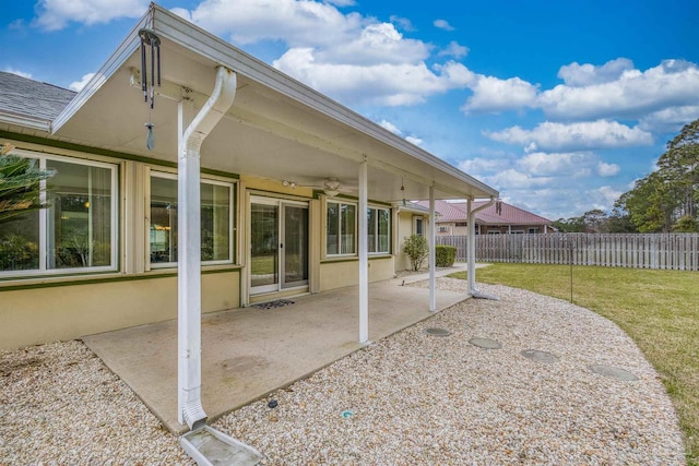 view of patio with fence and ceiling fan