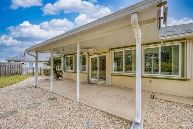 back of house featuring a patio area, stucco siding, fence, and ceiling fan