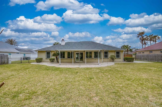 back of property featuring a fenced backyard, stucco siding, and a yard