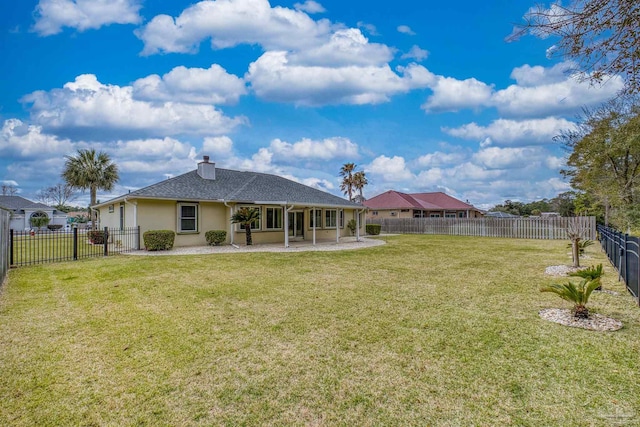 back of house featuring a patio area, a fenced backyard, a lawn, and stucco siding