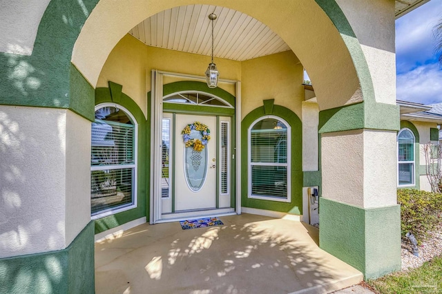 entrance to property with stucco siding