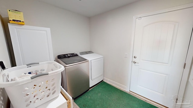 laundry room featuring dark carpet and washing machine and dryer