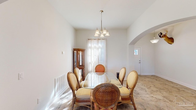 dining area featuring a chandelier