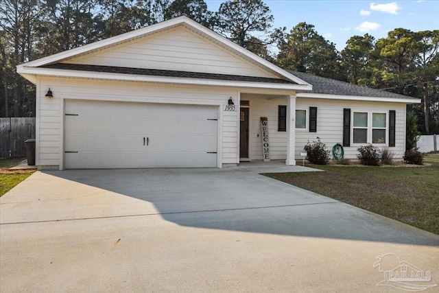 ranch-style house featuring an attached garage, a shingled roof, fence, driveway, and a front yard