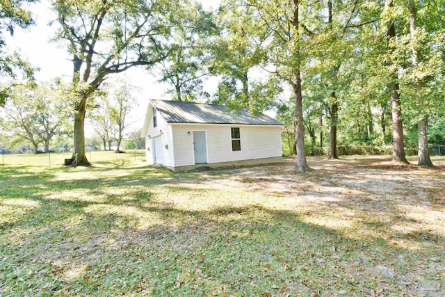 view of outbuilding featuring a yard