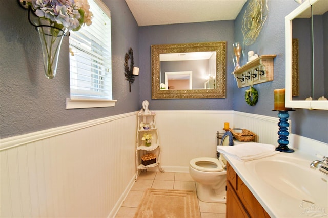 bathroom with tile patterned floors, vanity, and toilet