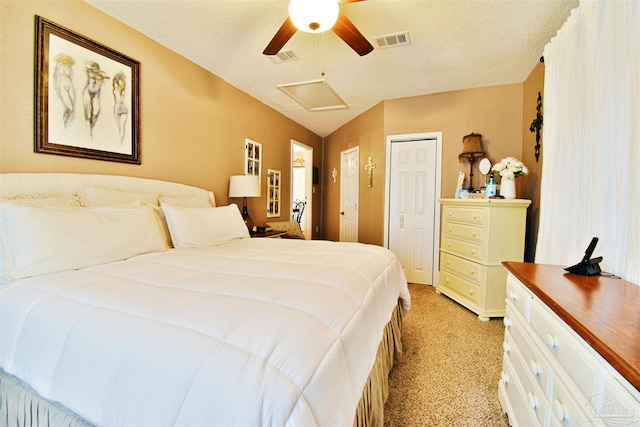 carpeted bedroom with ceiling fan, vaulted ceiling, and a textured ceiling