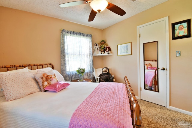 carpeted bedroom with ceiling fan and a textured ceiling