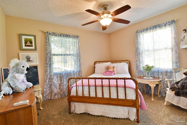 bedroom featuring ceiling fan, carpet, and a textured ceiling