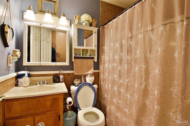 bathroom featuring vanity, tile walls, toilet, and a shower with shower curtain