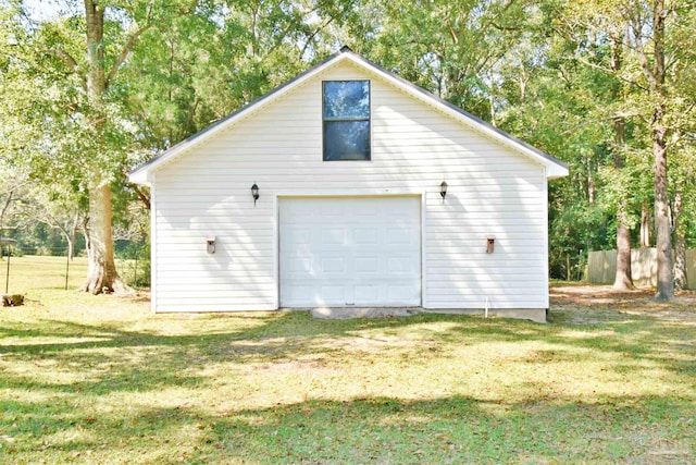 view of home's exterior with an outdoor structure, a garage, and a lawn