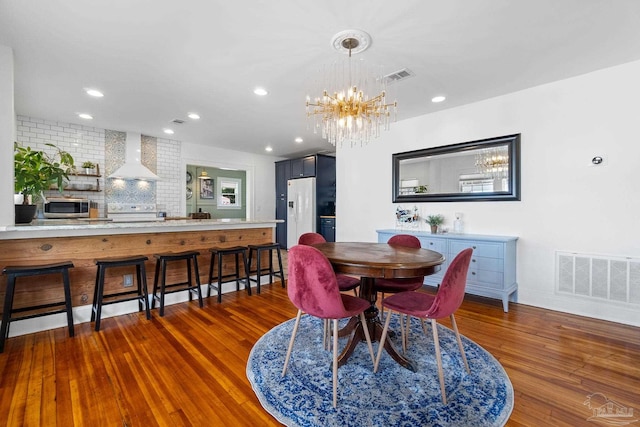 dining room featuring dark hardwood / wood-style flooring and a chandelier