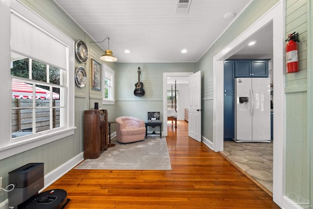 interior space with wood-type flooring and wooden walls