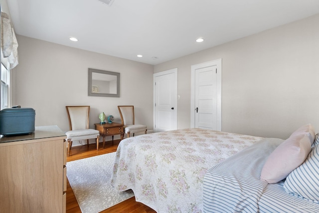 bedroom with hardwood / wood-style flooring