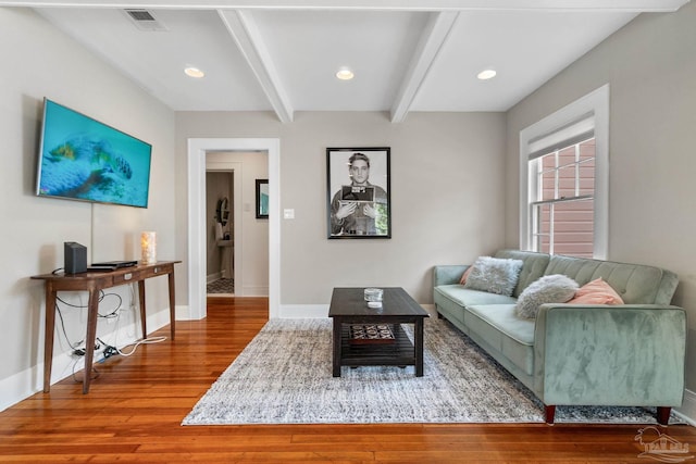 living room with hardwood / wood-style floors and beam ceiling