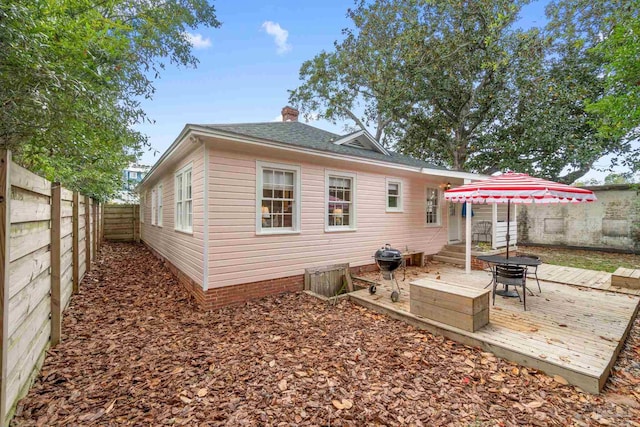 rear view of property with a wooden deck