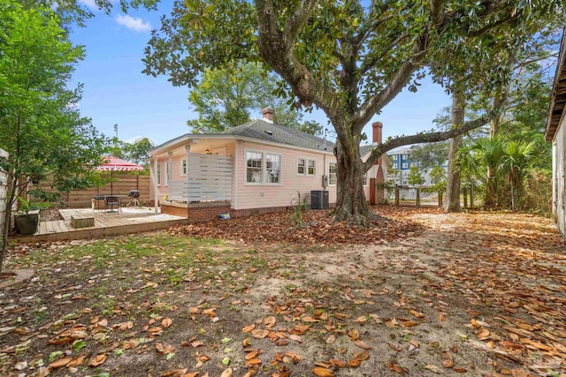 view of side of home featuring a wooden deck and central AC