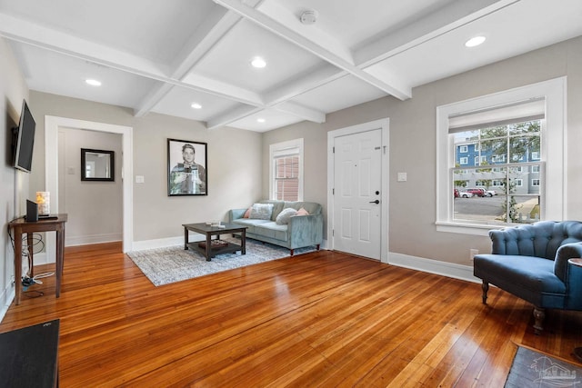 living room featuring coffered ceiling, wood-type flooring, and beam ceiling